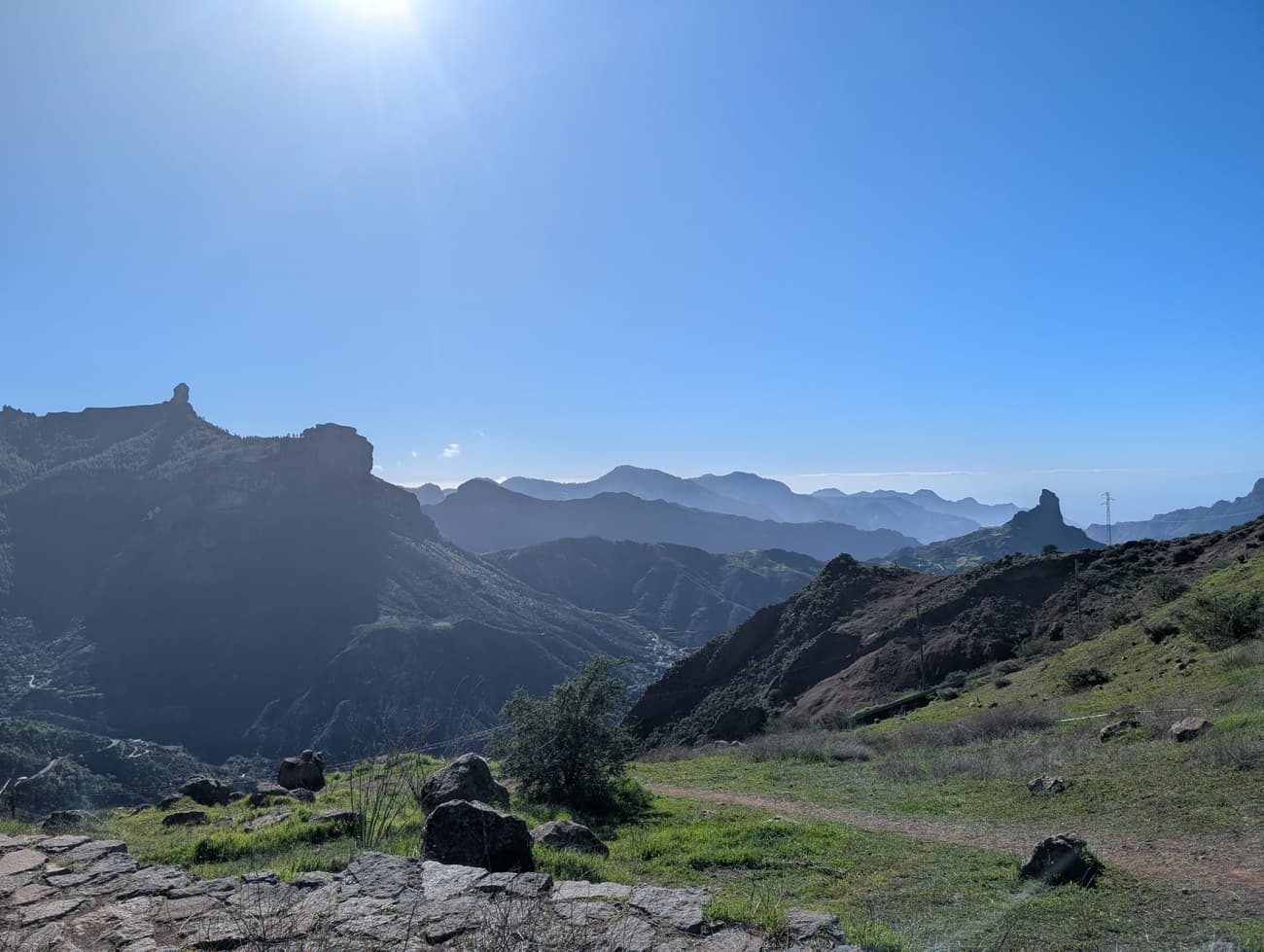 The caldera of central Gran Canaria in morning haze, Roque Nublo on the left skyline and Roque Bentayga standing out of the ridges to the right.