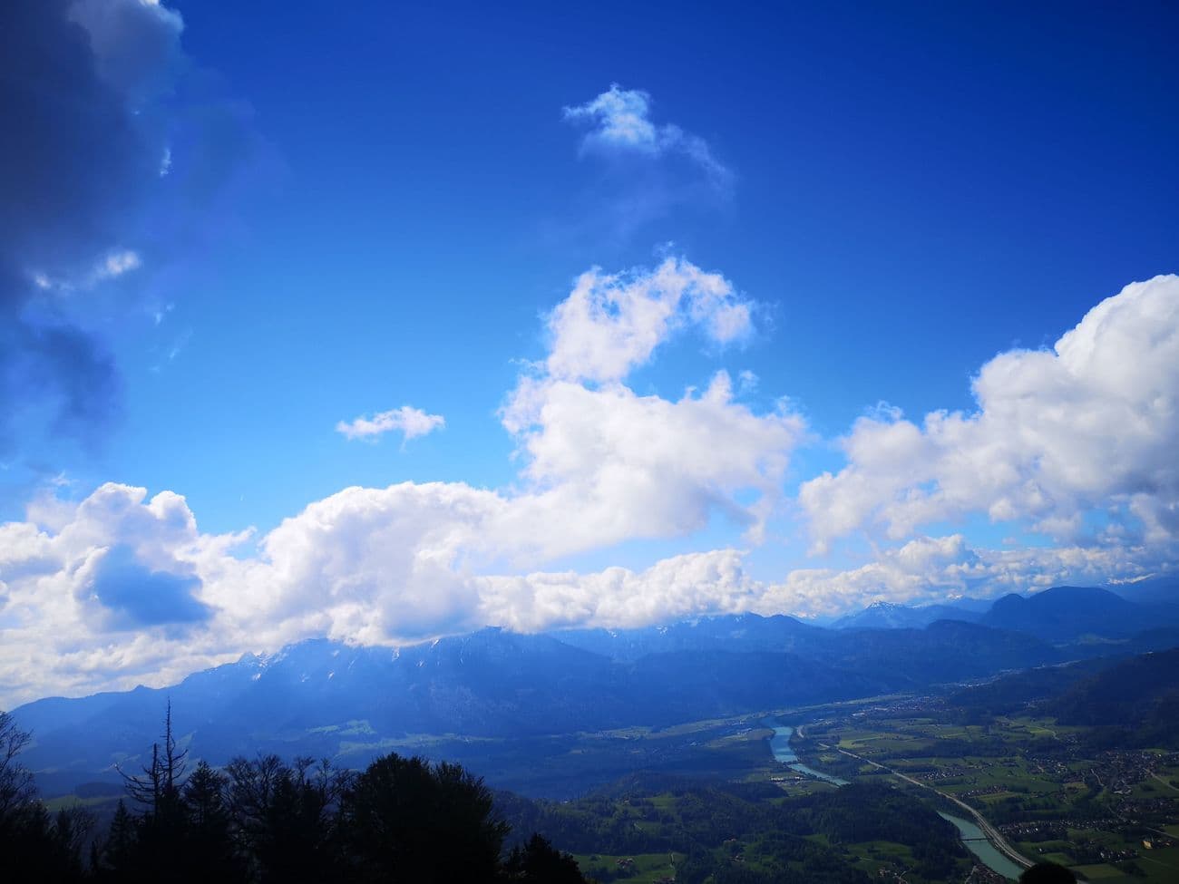 Towering cumulus over the Inn valley seen from the Kranzhorn, the Kaisergebirge ranged along the horizon.